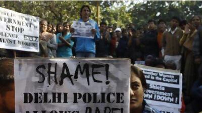 Women at a protest condemn police and authorities over the gang rape of a young woman on a city bus on Sunday.