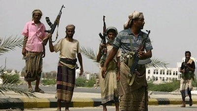 Pro-army tribesmen cross a street in the southern Yemeni city of Jaar. The army has just notched up its biggest victory in more than a year by recapturing two strategic cities.