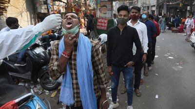 A health worker takes a sample to test for COVID-19 at a market area in New Delhi, India. India’s total number of coronavirus cases since the pandemic began has crossed 9 million. Nevertheless the country’s new daily cases have seen a steady decline for weeks now and the total number of cases represents 0.6% of India’s 1.3 billion population. AP Photo