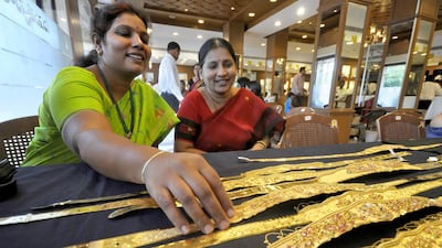 A woman checks a gold waist belt inside a jewellery shop in Hyderabad. India vies with China as the world’s biggest gold consumer. Krishnendu Halder / Reuters