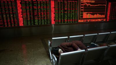 An investor rests at a securities company in Beijing on January 8 – the day after plummeting shares triggered a closure of Chinese markets and forced the government to restrict sell-offs by major shareholders. Beijing’s attempts to stabilise the markets panicked investors, causing more volatility across Asia and the wider global economy. Wang Zhao / AFP