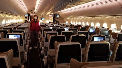 Rula Jarallah stands amid empty economy seats on-board an Etihad flight from Geneva to Abu Dhabi on Saturday. She and her husband, Sa-ed, were the only passengers on the plane. Courtesy: Sa-ed Jarallah