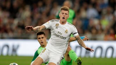 Real Madrid's Toni Kroos is tackled from behind. AP