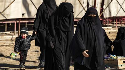 Women walk inside the Kurdish-run Al Hol camp in north-eastern Syria, where families of ISIS foreign fighters are held. AFP