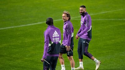 Real Madrid players Karim Benzema, right, and Luka Modric, centre, speaks with their teammate Antonio Rudiger during training. AP