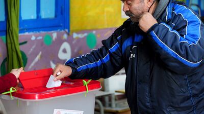 A Tunisian votes in the second round of the legislative elections in Tunis, Sunday, Jan. 29, 2023. AP