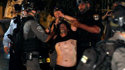 A Palestinian is detained by Israeli security forces during a protest. AFP