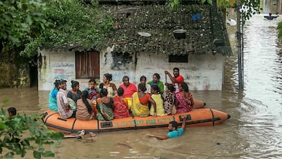 Volunteers rescue residents from a flooded street after heavy rainfall in Puducherry on December 2, after Cyclone Fengal hit Tamil Nadu. AFP