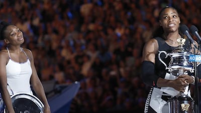 Serena Williams gives her winner’s speech as Venus looks on. Kin Cheung / AP Photo