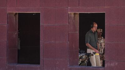 Prince William (C), Duke of Cambridge, is seen through the window of a building overseeing Kuwaiti and British soldiers taking part in the Exercise Desert Warrior at Sheikh Salem al-Ali al-Sabah Camp, about 40 kilometres north of Kuwait City. AFP