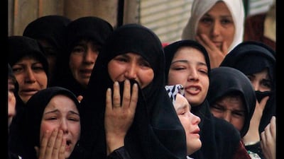 Mothers and relatives of dead Free Syrian Army fighters mourn during a symbolic Free Syrian Army funeral in Aleppo, Syria. Saad Abobrahim / Reuters