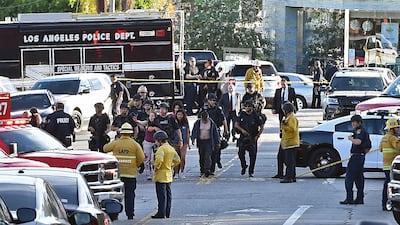 Police officers escort people from a supermarket after surrounding suspected shooter. AFP
