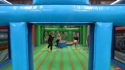 Air Maniax is for kids and adults alike. Seen here, Joanne Osgerby, left, with her daughter, Harriet, centre, and son, Henry, right. Pawan Singh / The National