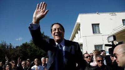 Nicos Anastasiades waves to his supporters after voting in the presidential election in Limassol, Cyprus, on Sunday. Petros Karadjias / AP Photo