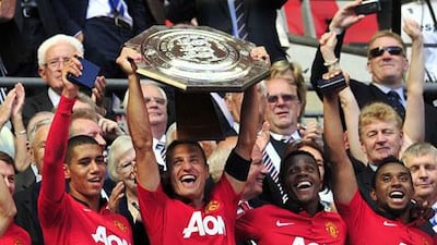 Nemanja Vidic wants Wayne Rooney to stay at 'the biggest club in the world'. Glyn Kirk / AFP