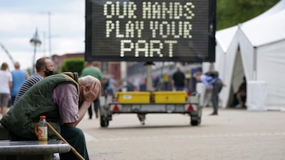 A man waits outside a mobile Covid-19 vaccination clinic outside Bolton Town Hall, north-west England. Cases of the Delta variant are rising in the town. AP