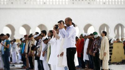 Muslims observe Eid prayers at the Sheikh Zayed Grand Mosque in Abu Dhabi. Christopher Pike / The National