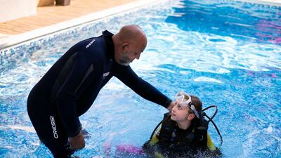 Ellie-May with her grandfather Ray Hewitt. The ten year-old is one of the world's youngest certified scuba diver. All photos by Reem Mohammed / The National