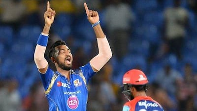 Mumbai Indians bowler Krunal Pandya, left, celebrates after he dismissing Delhi Daredevils captain Zaheer Khan at Dr. Y.S. Rajasekhara Reddy ACA-VDCA Cricket Stadium in Visakhapatnam on May 15, 2016. AFP / SAJJAD HUSSAIN