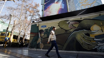 A billboard depicting Iranian missiles with a message in Persian and Hebrew reading 'prepare your coffins' on a building in Palestine Square, Tehran. EPA