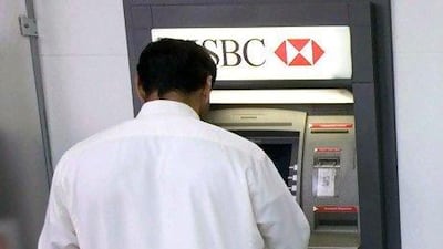 A customer withdraws money from an HSBC cash machine. Jaime Puebla / The National