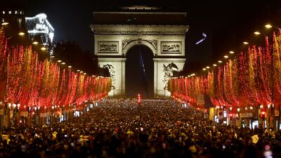 People attend New Year celebrations on the Champs-Elysees after a traditional light show and firework display were cancelled owing to the spread of the coronavirus. Reuters