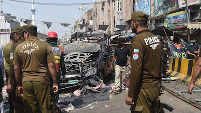 Officials examine the site of the bomb blast. AFP
