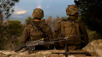 Israeli soldiers take a position along the Israel-Lebanon border on Wednesday after orders to leave were given to residents. AFP