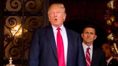 Donald Trump with Lt Gen Michael Flynn at Mar-a-Lago in Palm Beach, Florida on December 21, 2016, a month before Mr Trump was sworn in as the US president and appointed Mr Flynn as his national security adviser. Jim Watson / AFP