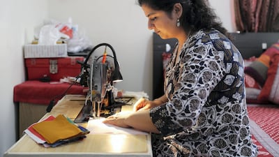 Tripti pictured sewing at her home in Dubai