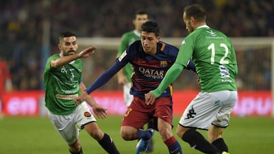 Barcelona’s Aitor Cantalapiedra tries to dribble through Villanovense players on Wednesday during their Copa del Rey round of 32 contest. Lluis Gene / AFP