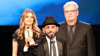 Iraqi director Mohanad Hayal receives Best Arab Director for 'Haifa Street' during the closing ceremony of the 41st Cairo International Film Festival. EPA
