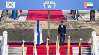 Sheikh Mohamed bin Zayed and Mr Moon stand for a national anthem during a reception at the Blue House. Hamad Al Mansoori / Ministry of Presidential Affairs