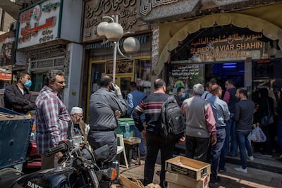 People in Cairo queue to buy fesikh, a fish dish traditionally eaten during the Sham El Nessim holiday in Egypt, which falls on April 20, 2020. AP Photo