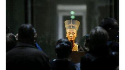 Visitors look at the bust of Queen Nefertiti on display at Berlin's New Museum. A reader argues that the ancient artefact should be returned to Egypt. Michael Gottschalk / AFP