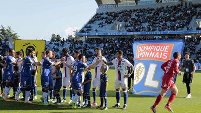 Lyon's players shake hands with Bastia's players before their Ligue 1 match on April 16, 2017 in Corsica. Pascal Pochard-Casabianca / AFP