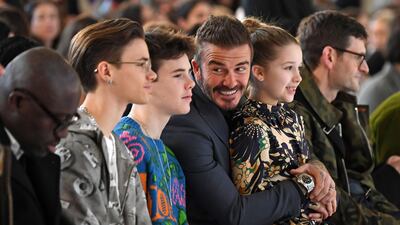 Romeo Beckham, Cruz Beckham, David Beckham and Harper Beckham in the front row for Victoria Beckham's autumn / winter 2020 show during London Fashion Week on February 16, 2020. AFP