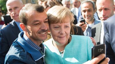 Angela Merkel. who was German chancellor at the time, poses for a selfie with a refugee in Berlin. AP.