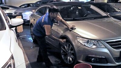 Car washers at Wafi Mall in Dubai wash the cars in stages during the summer months as the heat can become unbearable. Jeffrey E Biteng / The National