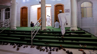 Worshippers go to a mosque close to the Sheikh Zayed Grand Mosque for Fajr on the first day of Ramadan. Victor Besa / The National