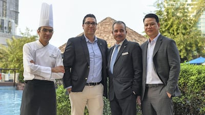 Some of Sheraton Abu Dhabi's long-serving employees. From left: Mustafa Almulla, a chef; Doj Puri, restaurant and bar manager; Hussein Tailoun, risk assessment; and Robert Yap, laundry manager. Khushnum Bhandari for The National