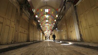 epa08578304 A Palestinian man walks in an empty street in Nablus, West Bank, 01 August 2020. Palestinian authorities have announced a three-day lockdown during the Eid al-Adha holidays. Eid al-Adha is the holiest of the two Muslims holidays celebrated each year, it marks the yearly Muslim pilgrimage (Hajj) to visit Mecca, the holiest place in Islam. Muslims slaughter a sacrificial animal and split the meat into three parts, one for the family, one for friends and relatives, and one for the poor and needy. EPA/ALAA BADARNEH
