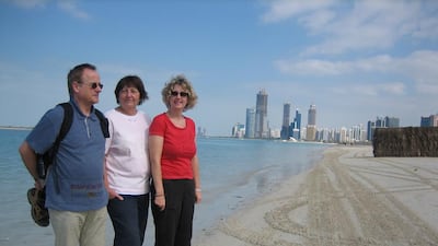 Monika, centre, and Stephanie Wawrzinek with Hanns Wawrzinek at the Abu Dhabi corniche in January 2012. Courtesy Stephanie Wawrzinek