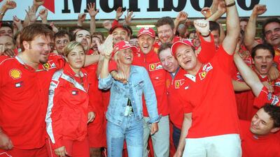 Michael Schumacher with his wife Corinna and the Ferrari team in Suzuka in 2000. Getty