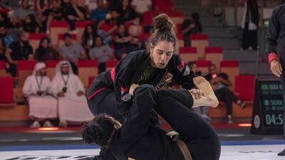 Yara Nascimento, top, during her win over Silvia Scomparin on Day 3 of the Jiu-Jitsu Abu Dhabi Grand Slam World Tour. Antonie Robertson/The National