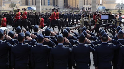 Officers salute as the coffin carrying Mubarak passes by. EPA