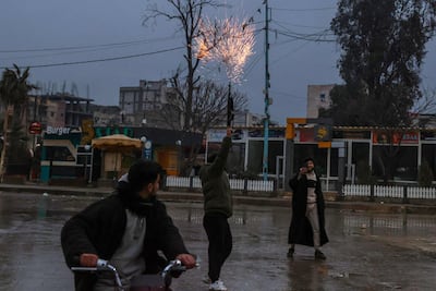 A soldier fires his rifle into the air in celebration after Syrian government forces entered the northern city of Raqqa on Sunday. AFP