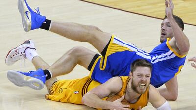 Cleveland Cavaliers guard Matthew Dellavedova of Australia (bottom) grabs a loose ball while drawing a foul on Golden State Warriors forward David Lee (top) in the second half of Game Three of the NBA Finals at Quicken Loans Arena in Cleveland, Ohio, USA, 09 June 2015. The winner of best of seven series will be NBA Finals Champions. EPA/LARRY W. SMITH CORBIS OUT