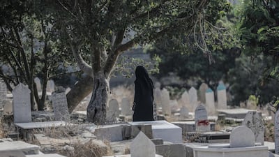 Palestinians visit the grave of their relatives in Gaza City. EPA