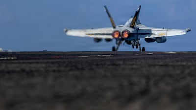 A warplane takes off from the USS Abraham Lincoln in the Indian Ocean last week. The aircraft carrier group is now within striking distance of Iran. AP